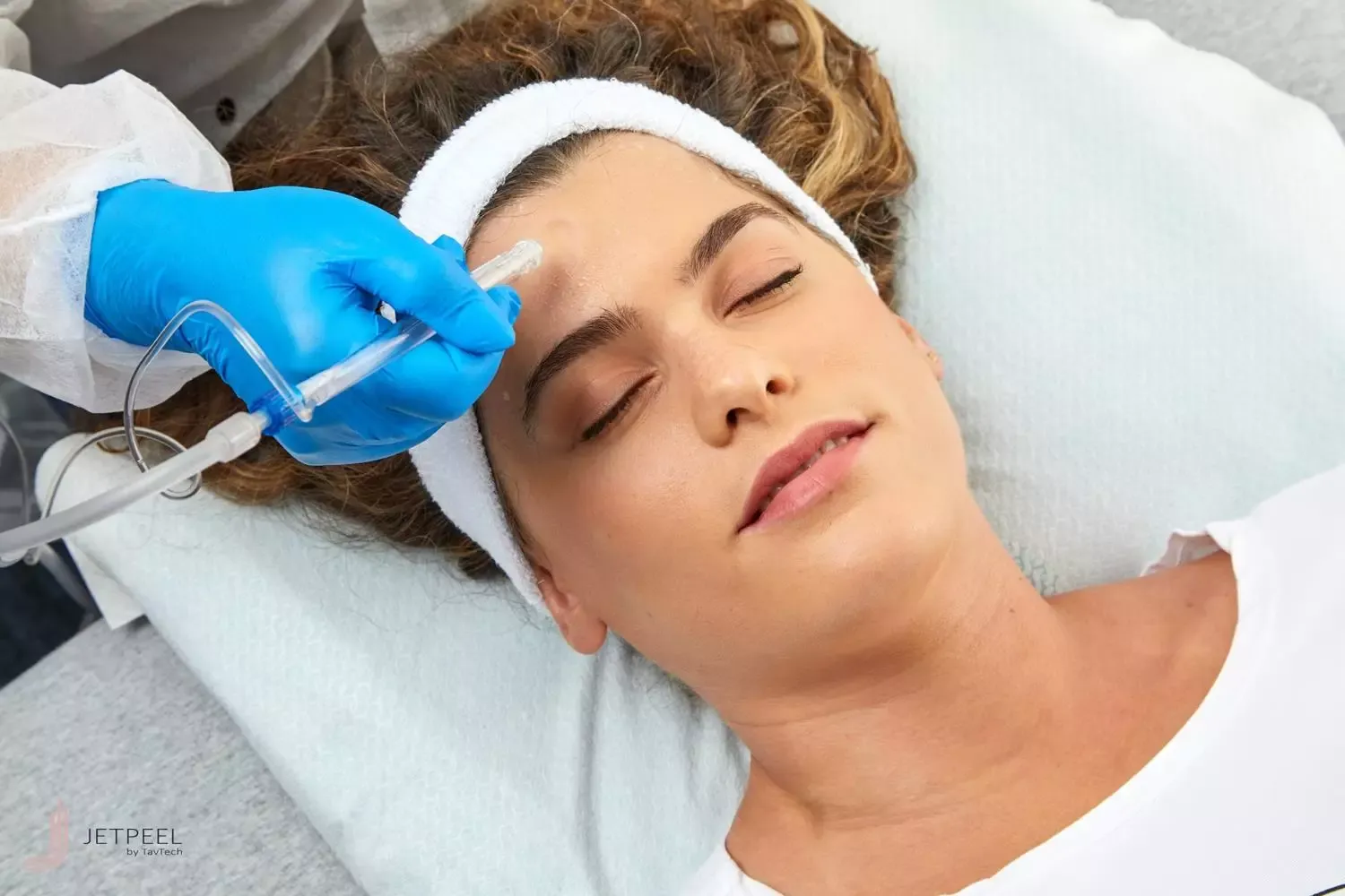 Femme recevant un traitement facial JetPeel avec appareil professionnel de soins de la peau
